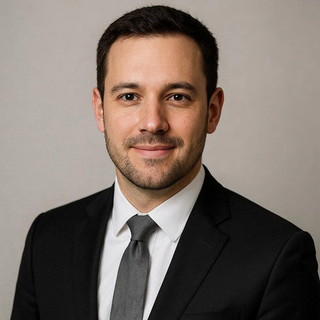 Portrait of a handsome young man in a black suit and tie