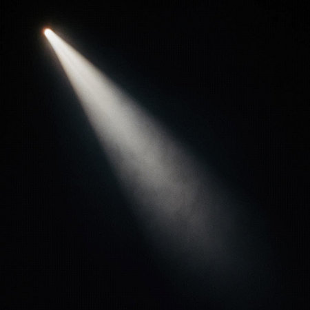 Spotlight on a black background with rays of light coming from above