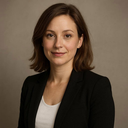 Portrait of a smiling businesswoman in a black suit on a gray background