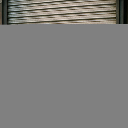 A vertical shot of a roller shutter in a shop with copy space