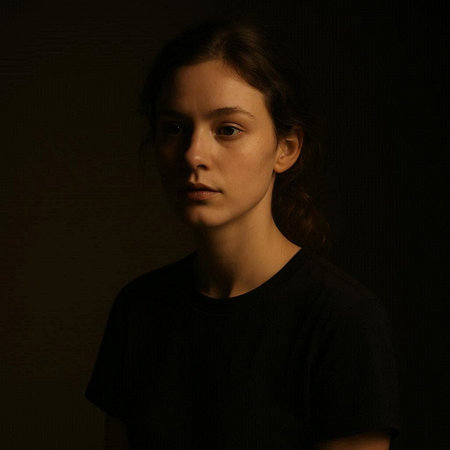Portrait of a young girl in a black T-shirt on a dark background
