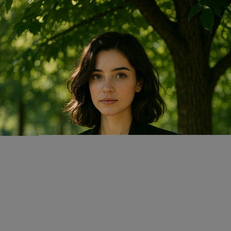 Portrait of a beautiful young woman with dark hair in a park