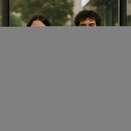 Portrait of a young couple looking at the camera in the city