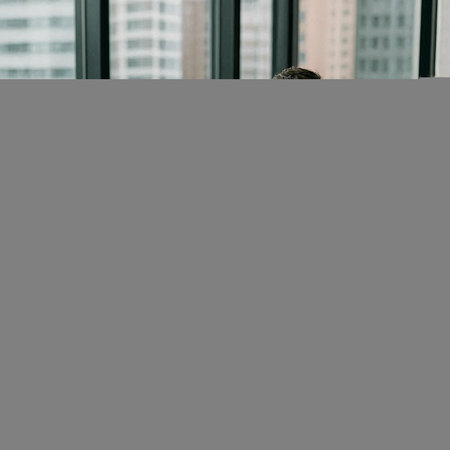 Businessman looking out the window in the office. Business concept.の写真素材