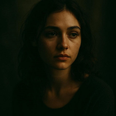 Portrait of a beautiful girl with long hair in a dark room