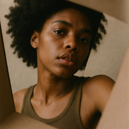 Portrait of a young african american woman looking through a window