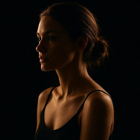 Portrait of a beautiful young woman in sportswear on black backgroundの写真素材