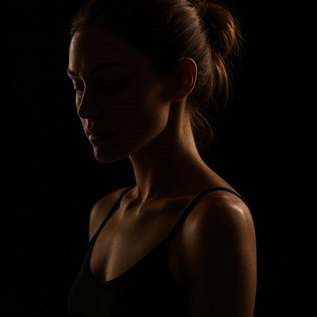 Portrait of a beautiful young woman on a black background in low key