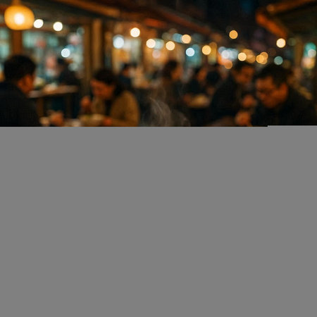 Blurred image of people in the coffee shop at night time.