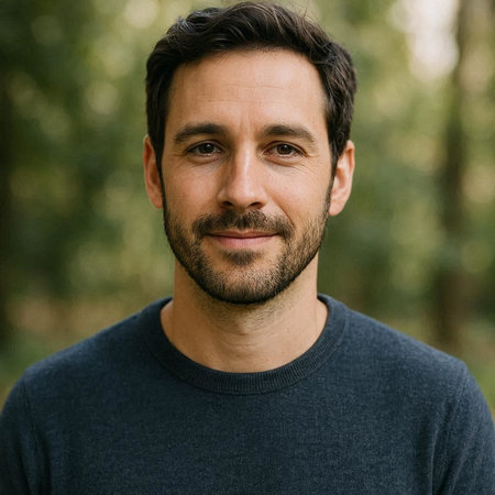 Portrait of a handsome young man with beard and mustache in the forest