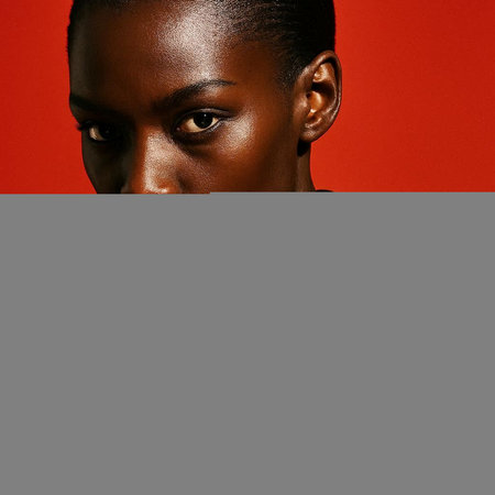 Beautiful african american woman portrait on red background. Studio shot.の写真素材