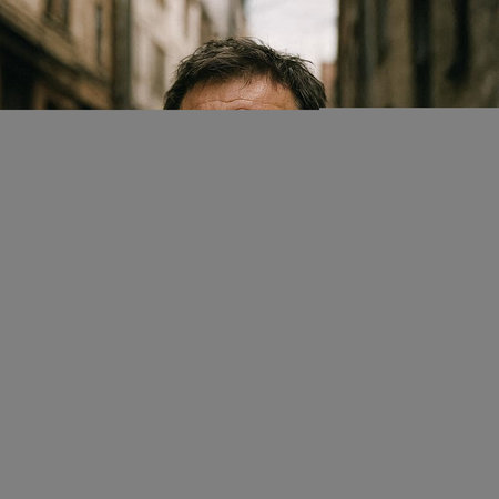 Handsome man with gray hair on the street in the city