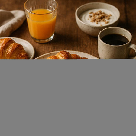 Breakfast with coffee, orange juice and croissants on wooden table