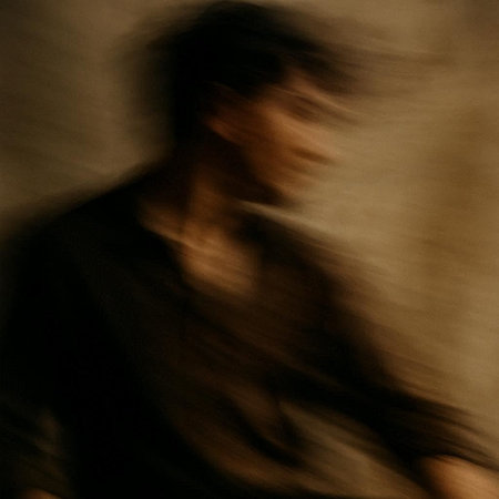 abstract background with blurred silhouette of a man in a black shirt