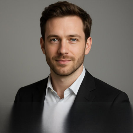 Portrait of a handsome young man in a suit on a gray background