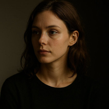 Portrait of a young woman on a dark background. Studio shot.