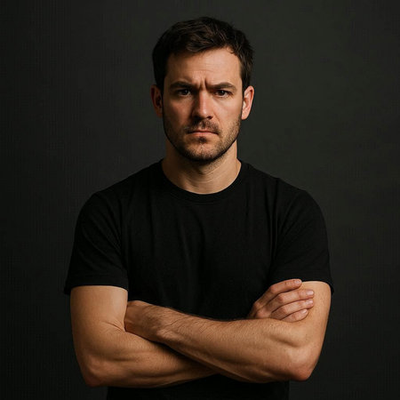 Portrait of a handsome man in black t-shirt on dark background