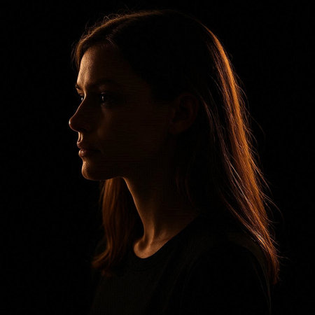 Portrait of a beautiful young woman in profile on a black background