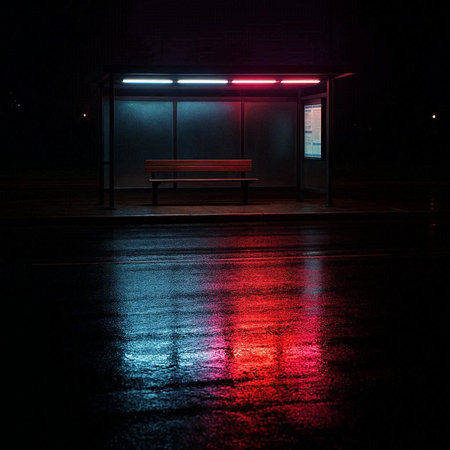 Empty bus stop at night with a red light on the ground.の写真素材