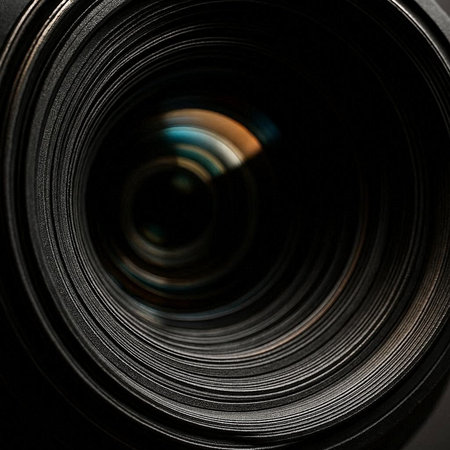close up of a camera lens with shallow depth of field on black background