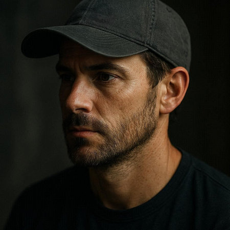 Portrait of a man in a baseball cap on a dark background