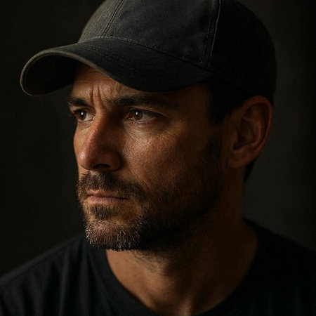 Portrait of a serious man in a cap on a dark background