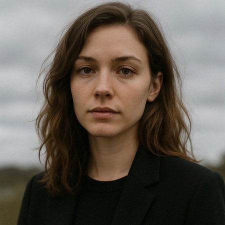Portrait of a beautiful young woman with long brown hair in a black coat