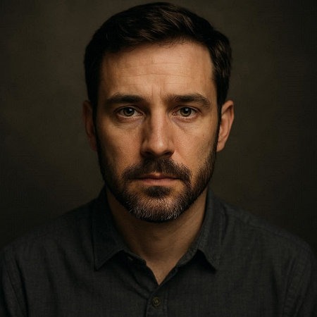 Portrait of a handsome man with a beard and mustache on a dark background