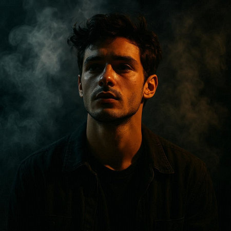 Portrait of a young man in a dark room with smoke.