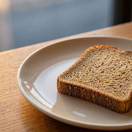 Slices of bread on a plate on a wooden table.