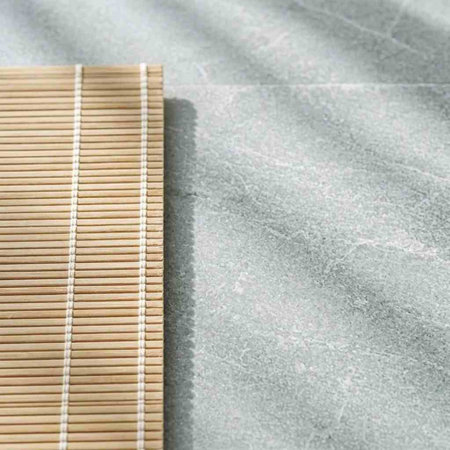Bamboo mat on a marble background. Copy space for text.