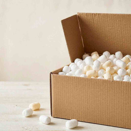 Cotton candy in a cardboard box on a white background. Selective focus.