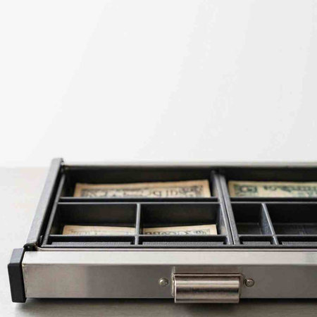 Dollars in a metal case on a white background. Copy space.