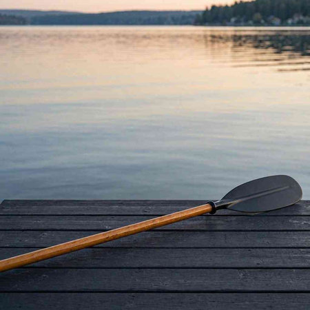 Wooden stand up paddle on a wooden pier on a lake.