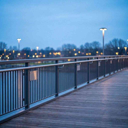Pedestrian bridge over the river at night in the city.