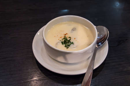 Mushroom soup with a swirl of cream and bread の写真素材