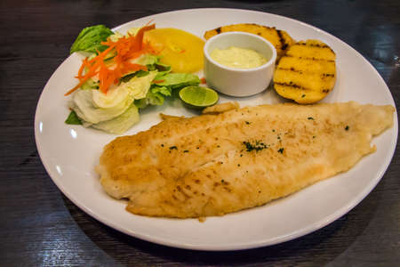 Fish steak dolly with salad の写真素材