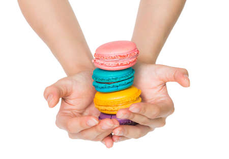 Isolated Hand holding Colorful macaronsの写真素材