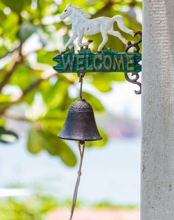Welcome sign and bell in fresh morning の写真素材