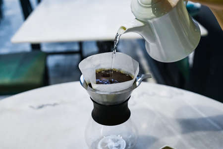 Drip brewing, filtered coffee, or pour-over is a method which involves pouring water over roasted, ground coffee beans contained in a filter.の写真素材