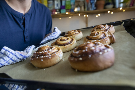 Man baking cinnamon buns