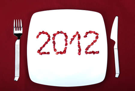 The numbers 2012 is written from the garnet grains on a plate