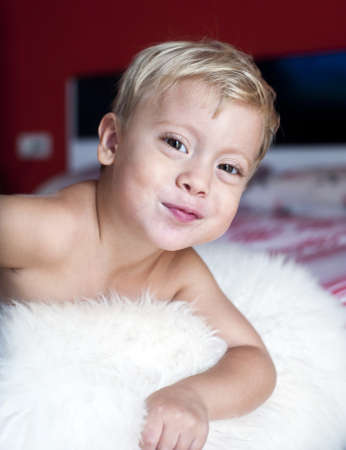 The little boy on a red backgroundの写真素材