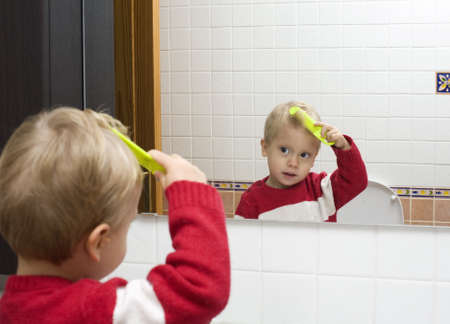 The little boy combs hairの写真素材