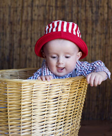 The wonderful kid in a red cap and in a basket の写真素材