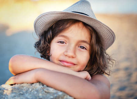 Sweet girl in a hat against natureの写真素材