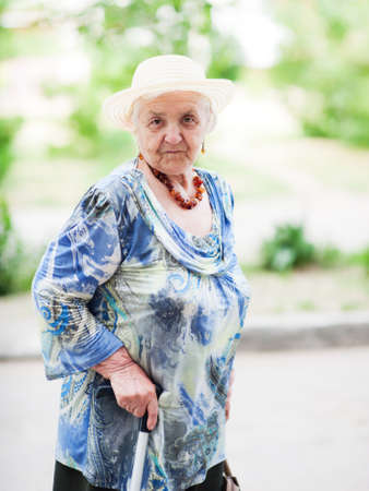Portrait of an elderly woman on a background of nature