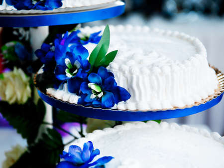 Sweet cake garnished with artificial blue flowersの写真素材