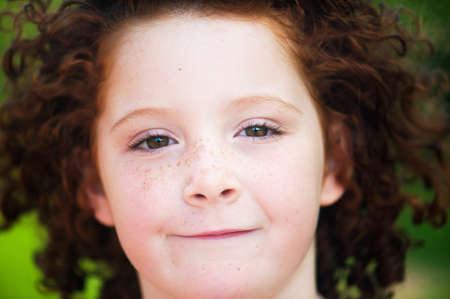 Redheaded beautiful girl on a background of nature