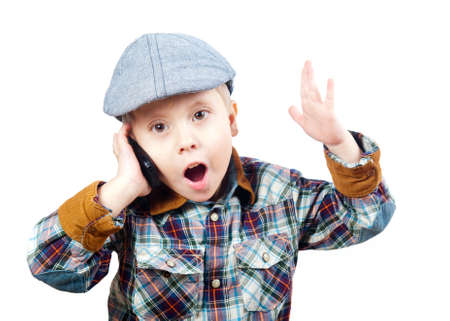boy in a cap on the phone isolated on white backgroundの写真素材